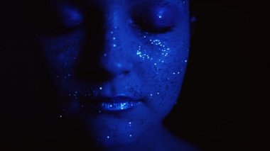 creative glitter makeup woman sparkling face blue