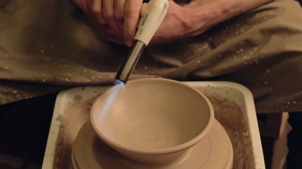 Pottery manufacturing artist glazing clay bowl — Stock Video