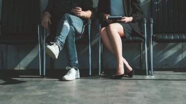job application man woman sitting chairs waiting