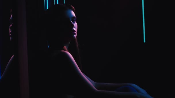 Neon lights girl chilling out colored illumination — Stock video