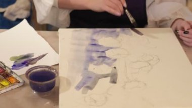 art school woman hand painting watercolor canvas