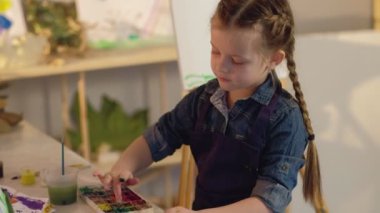 talented kid leisure girl finger painting easel