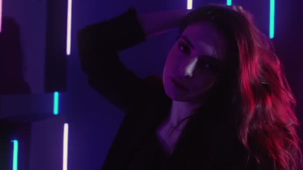 Colored lights face relaxed girl dancing neon glow — Stock video