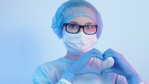 Doctor portrait female physician ppe hand heart — Stock Video