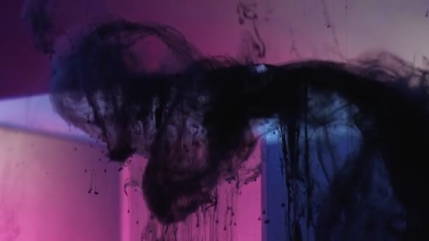 Tinta preta gotejamento fumaça fluxo cubo de vidro luz rosa — Vídeo de Stock