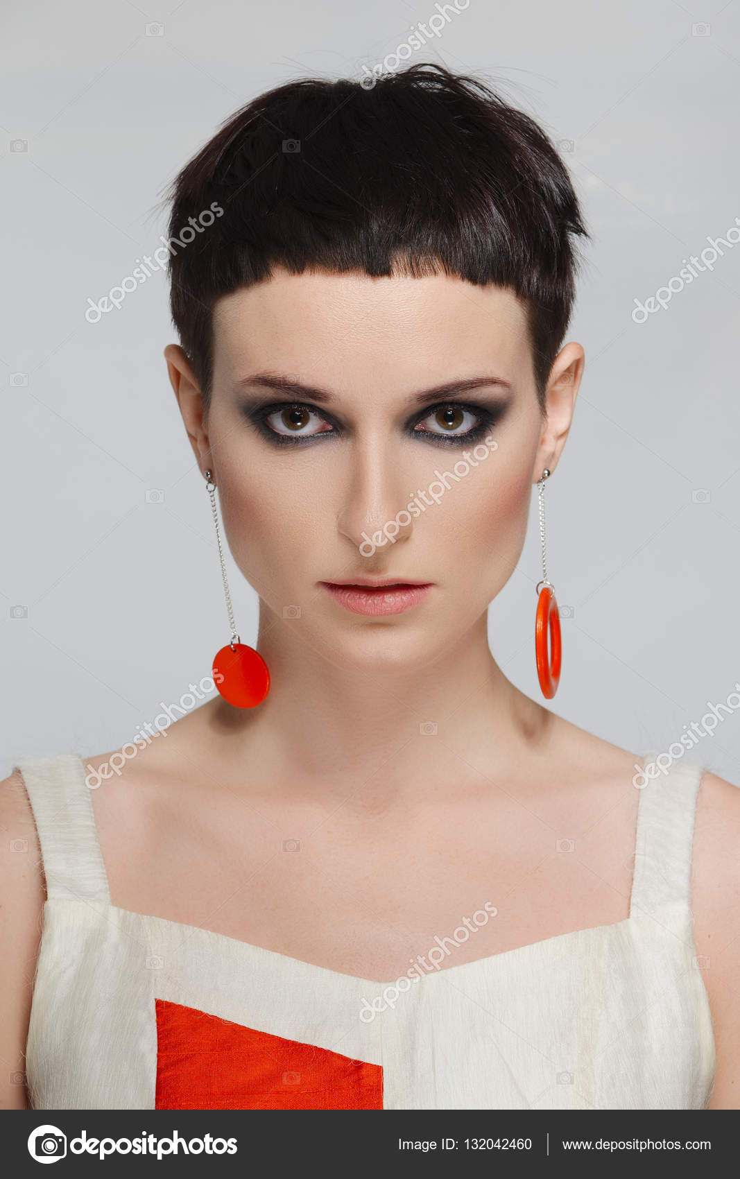Pretty Young Woman With Short Black Hair And Red Earrings Short