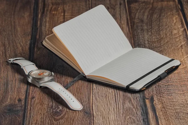 Açık boş defter kalem ve bilek seyretmek ahşap tablo ile.