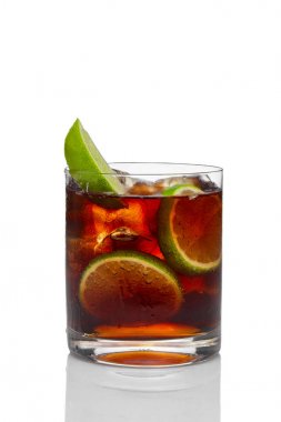 Cocktail with rum and cola with ice and lime in oldfashioned gla clipart
