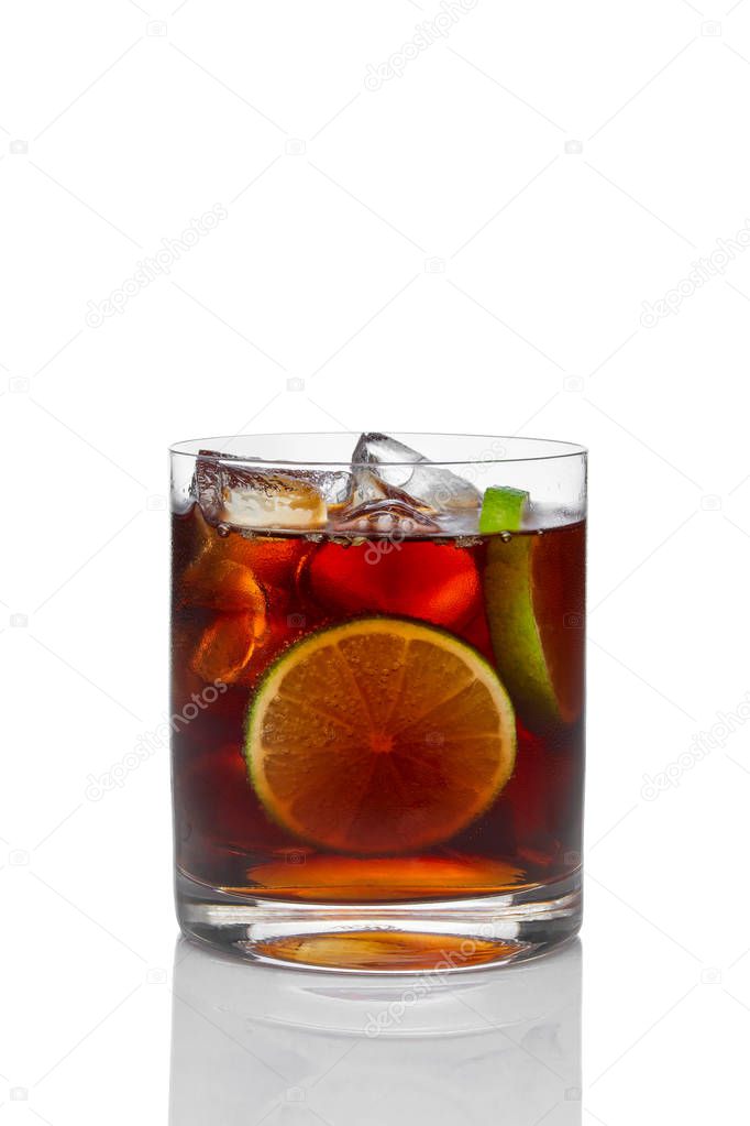 Cocktail with rum and cola with ice, lime and lemon in oldfashio
