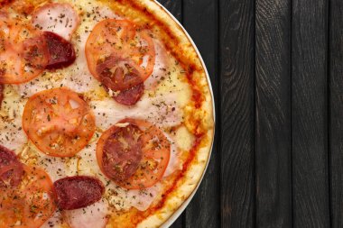 Lezzetli pizza biberli üstten görünüm koyu ahşap arka plan üzerinde