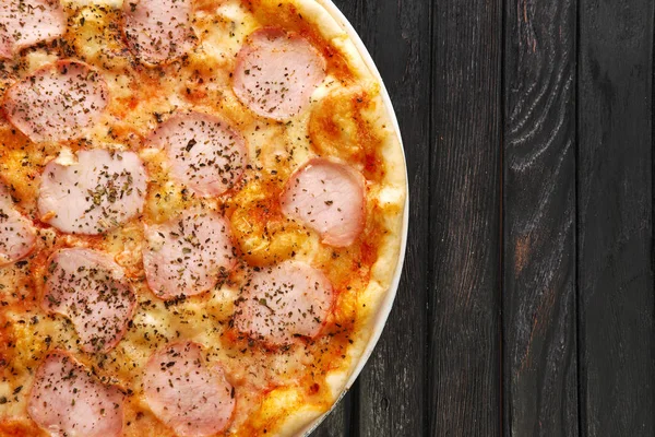 Koyu ahşap zemin üzerine lezzetli Pizza jambon ile Üstten Görünüm