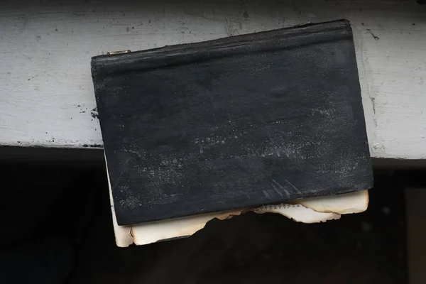 Old burnt book with teared out pages on window sill