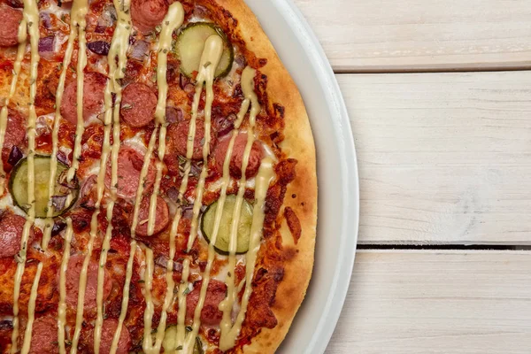 Top view of pizza with sausage and pickled cucumber — Stock Photo, Image