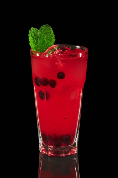 Glass of currant mors, berry compote on black background with reflection — Stock Photo, Image