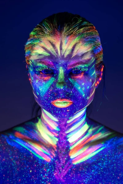 Portrait of beautiful girl with ultraviolet paint on her face. G