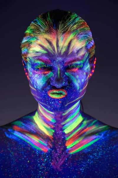 Portrait of beautiful girl with ultraviolet paint on her face. G