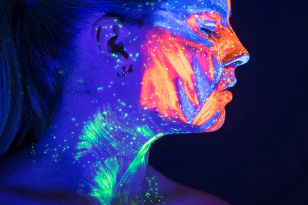 Portrait of beautiful girl with ultraviolet paint on her face. G