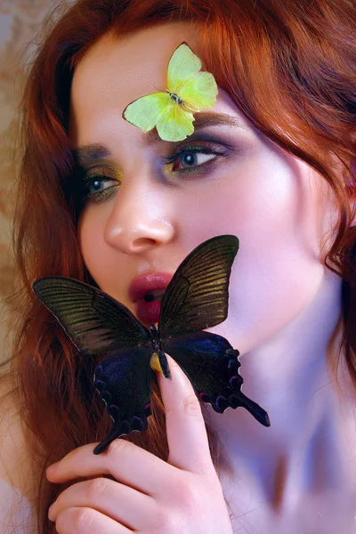 Close up portrait of tender girl with butterflies on her face and body