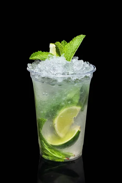Cold lime and mint cocktail with a sparkling wine with ice in take away glass isolated on black — Stock Photo, Image