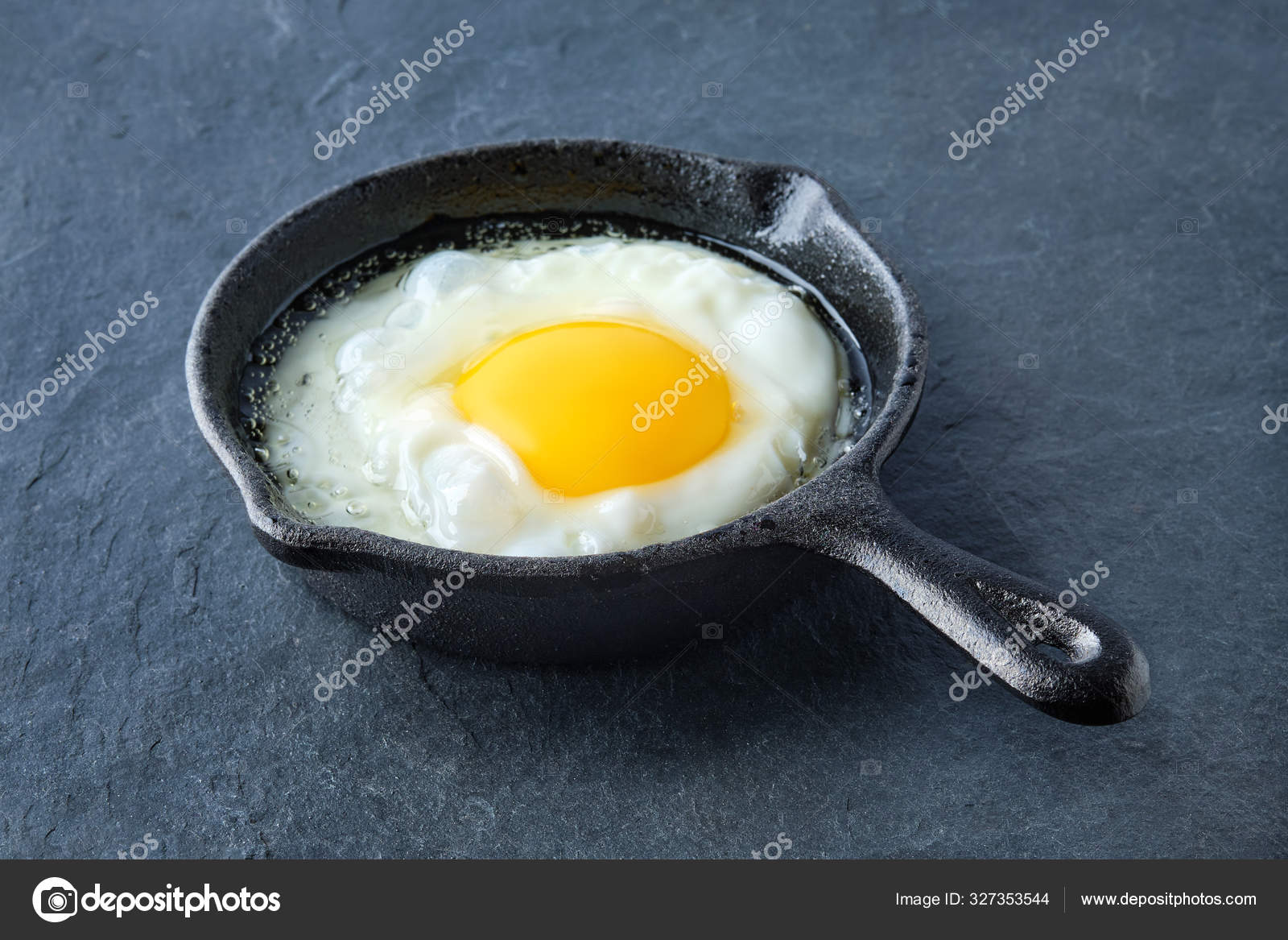 Scrambled egg in small cast-iron skillet. Making omelet eggs. Stock Photo  by ©boomeart 327353544