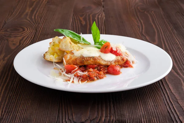 Filete de pollo asado con cereza de tomate, parmesano y croutón sobre fondo de madera oscura —  Fotos de Stock