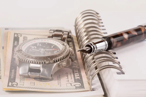 Classic Watch with a dollar, model on dollar banknotes and pen, notebook