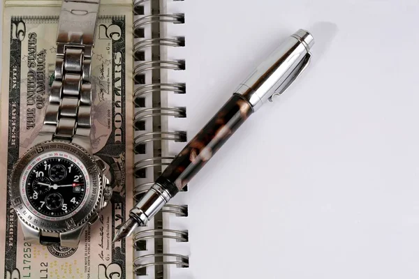 Classic Watch with a dollar, model on dollar banknotes and pen, notebook