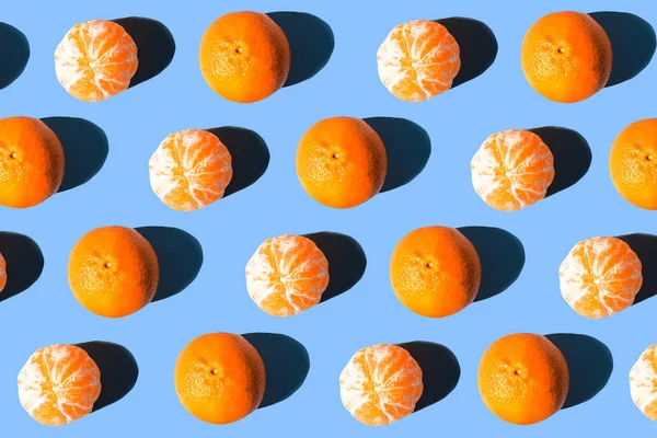 Fruit pattern  mandarins isolated on blue or mint background, top view.