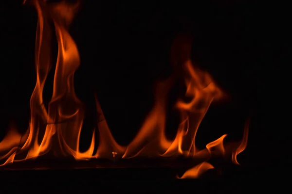 Schöne Feuerflammen auf schwarzem Hintergrund. — Stockfoto