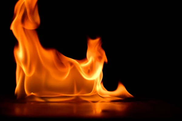 Beautiful fire flames on black background. — Stock Photo, Image