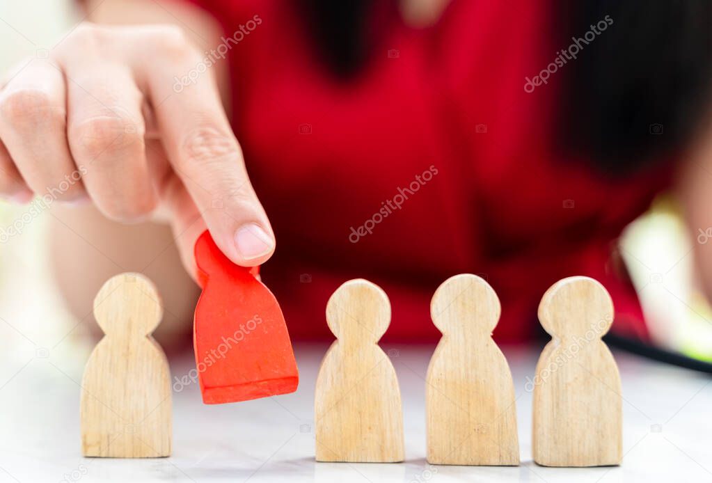 Figure in human resource management concept. The red wood figure was picked out of its group. Red Wood figure like who is selected from the candidate, or choose the most dominant in the team