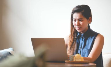 Blogger, Asyalı Kadın Yazarları, seyahat konsepti sosyal medya takipçilerine yazmak, hikayeler anlatmak veya seyahat değerlendirmeleri yapmak için kafeteryada dizüstü bilgisayarlar kullanıyorlar.