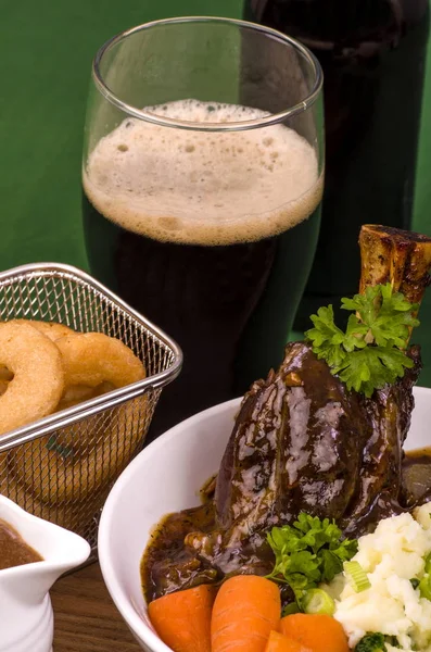 Lamb Shank Dinner.Traditional St Patricks Day Lamb Shank served with Colcannon, Stout battered onion rings and a glass of Irish Stout.