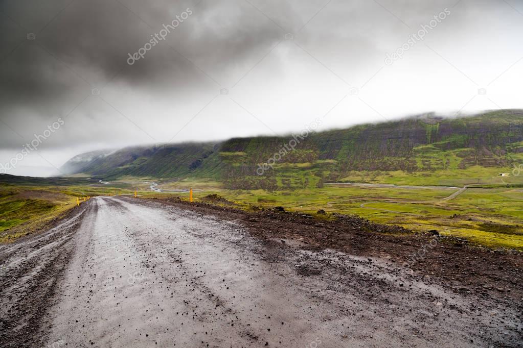 Empty gravel road in rural Iceland in the fog