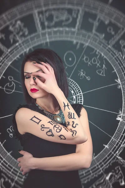 Caucasian brunette with signs of the zodiac — Stock Photo, Image
