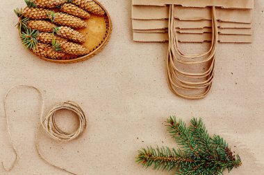 El yapımı hediyeler Noel ve onlar için ihtiyacın olan her şey. Kraft kağıt, çam dalları ve jüt kordon çanta. Üstten Görünüm, sadelik ve minimalizm kavramı