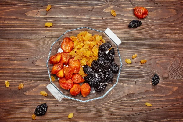 Mix dried fruits collection. On a wooden background. Dried fruits are stored without a refrigerator for a long time.