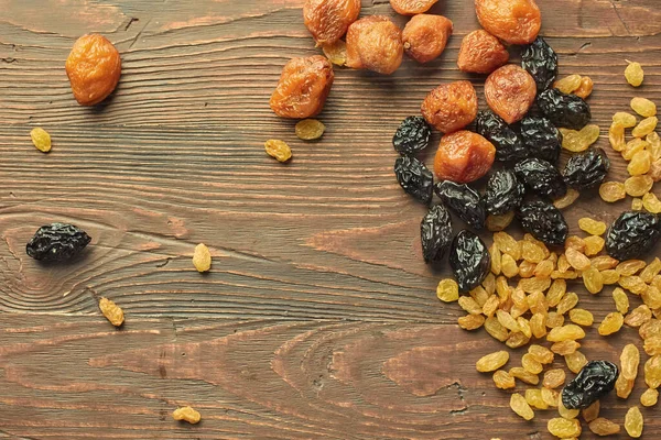Close-up of mixed dried fruits - dried apricot, prunes and grapes. The concept of long-term storage of food stocks without a refrigerator.