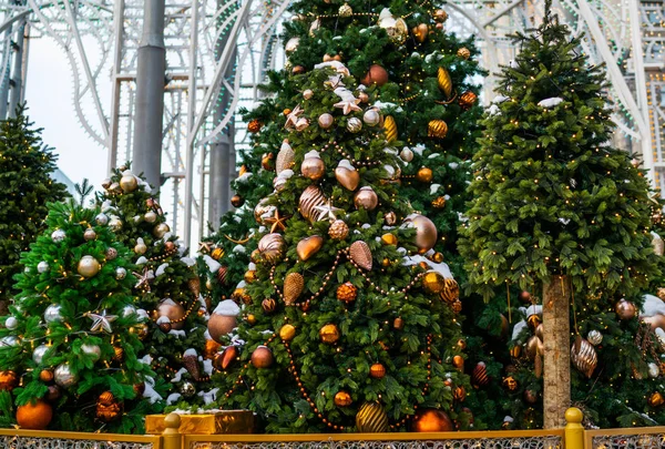 Decorated outdoor Christmas Tree with beautiful festive arrangement of fresh spruce with balls. Christmas morning. Festive street decor in winter holidays.