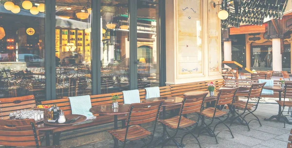 Cozy street with tables of cafe old town street in Chamonix village, France. Architecture and landmark. Cozy cityscape. Typical view of the street with tables of cafe in Chamonix.