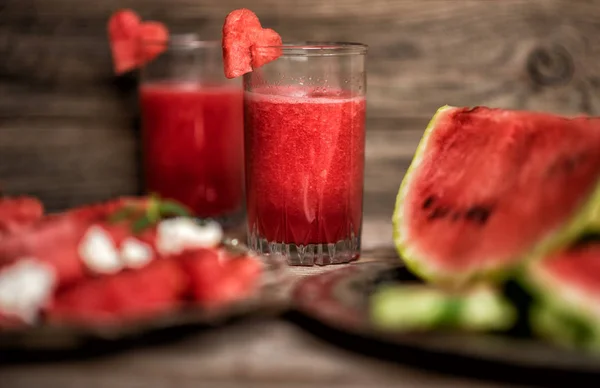 Fresh summer watermelon salad with feta cheese, arugula, onions on rustic background.