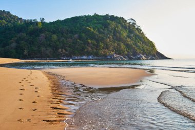 Harika bir kumsal. Tropikal sahilde güzel bir gün doğumu. Sahilde altın kum. Tropik Tioman Adası 'nın cennet manzarası, güneşin doğuşu. Yaz, tatil, açık hava gezisi konsepti.