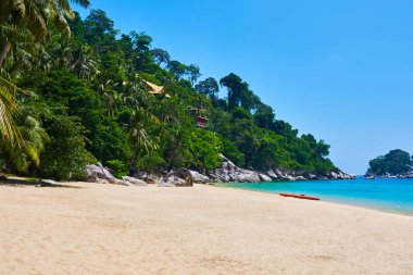 Altın kum plajı ve turkuaz deniz arka planı. Güneşli bir günde deniz ve gökyüzünün arka planında kıyı şeridi, altın kum, turizm, rahatlama, tatil, yaz, okyanus. Tioman Adası, Malezya.