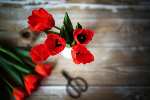 Spring flowers. Tulips flowers on rustic wooden background. Copy space.