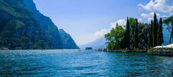 Beautiful nature background. Panorama of the gorgeous Lake Garda surrounded by mountains, Italy.