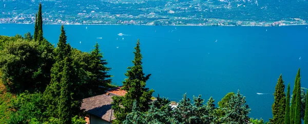 Beautiful nature background. Panorama of the gorgeous Lake Garda surrounded by mountains. Scenic sight in Tremosine sul Garda, village on Lake Garda, in the Province of Brescia, Lombardy, Italy.