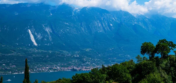 Beautiful nature background. Panorama of the gorgeous Lake Garda surrounded by mountains. Scenic sight in Tremosine sul Garda, village on Lake Garda, in the Province of Brescia, Lombardy, Italy.