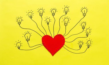 Soyut kesimine ve Sarı zemin üzerine kırmızı kalp. Sevgi ve enerji kavramı.