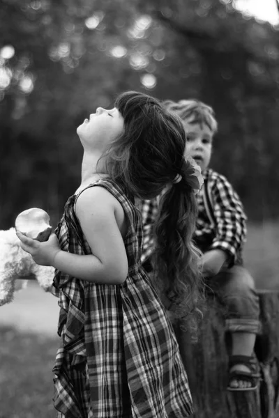 Smiling cheerful boy and girl playing in the pirates outdoors. Lifestyle childhood concept. Black and white