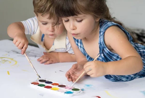 Kids playing and painting at home or kindergarten or playschool